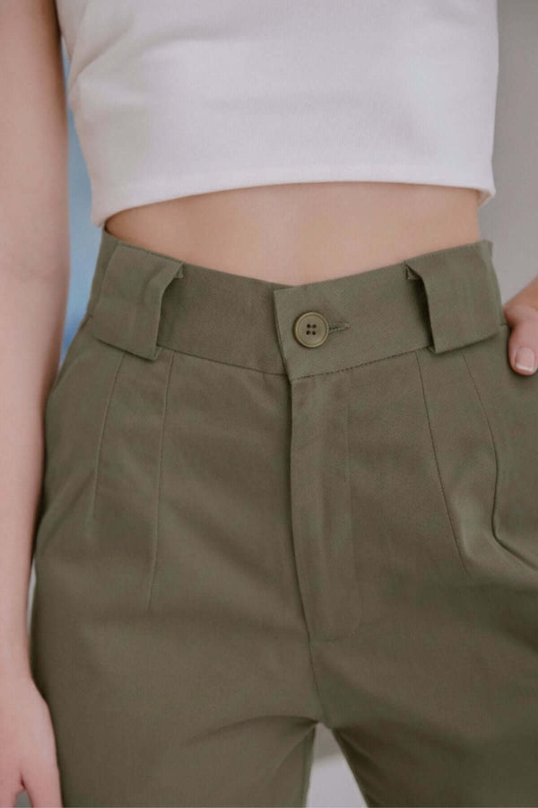 Calça Alfaiataria Algodão Oliva com botão, detalhe de cintura alta e tecido 100% algodão durável e confortável.